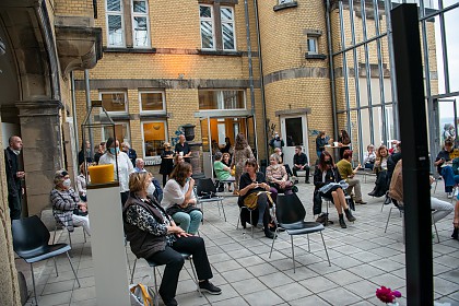 Guests watch the livestream in the courtyard